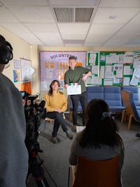 a group of people in a room with a camera